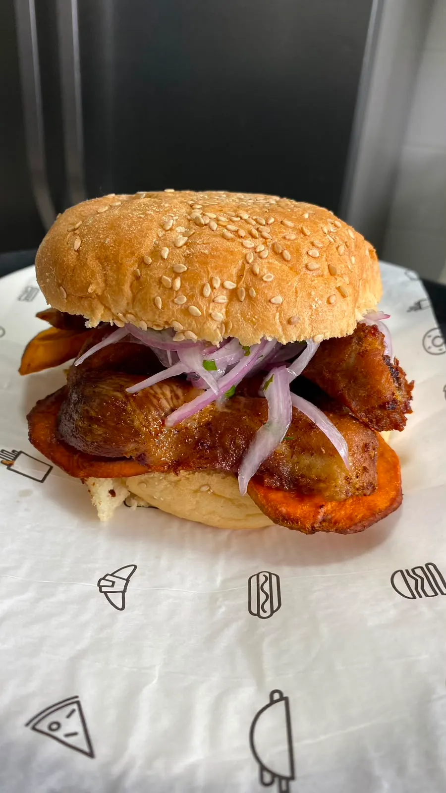 Sándwich de chicharrón con camote y salsa criolla